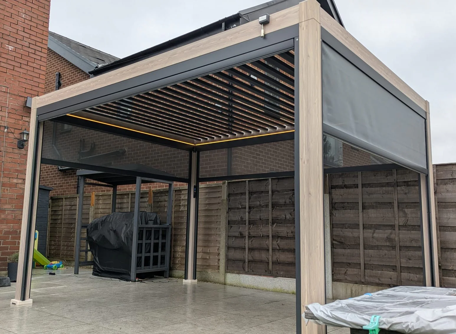 LuxShade™ 3×4m Oak Effect Aluminium Pergola with LEDs, Double-Layered Louvres - Image 4